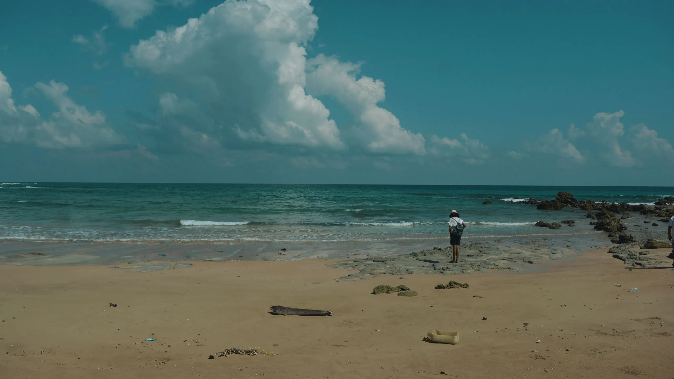 A quiet beach in the Andaman islands, a cloud rising over the sea